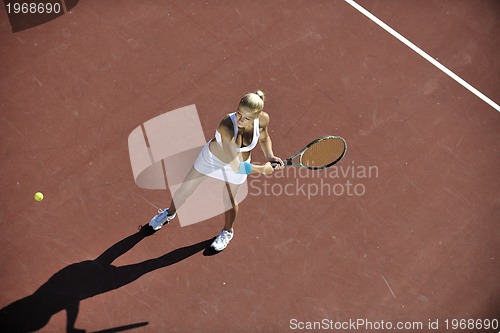 Image of young woman play tennis outdoor