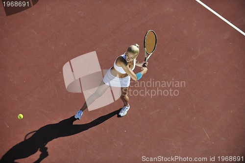Image of young woman play tennis outdoor