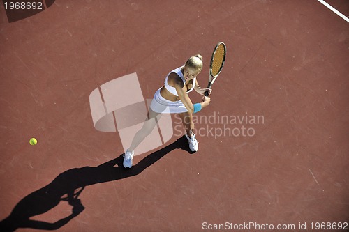Image of young woman play tennis outdoor
