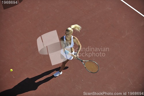 Image of young woman play tennis outdoor