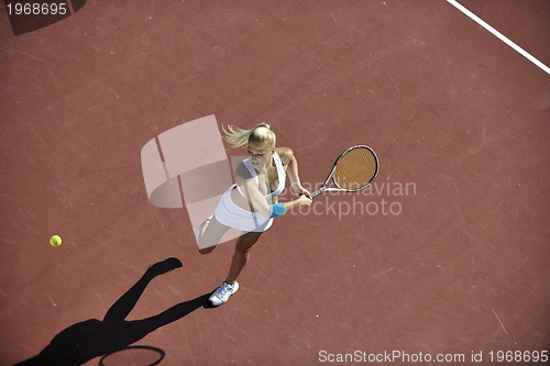 Image of young woman play tennis outdoor
