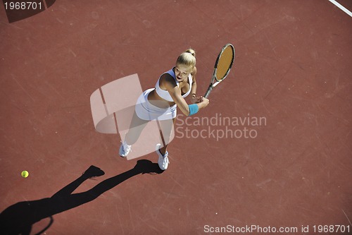 Image of young woman play tennis outdoor