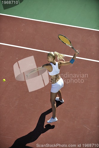 Image of young woman play tennis outdoor