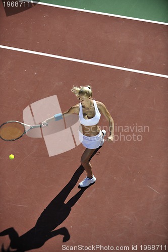 Image of young woman play tennis outdoor