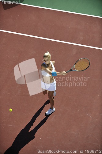 Image of young woman play tennis outdoor