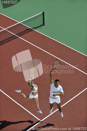 Image of happy young couple play tennis game outdoor