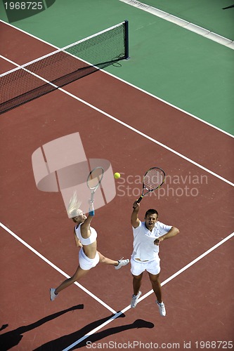Image of happy young couple play tennis game outdoor