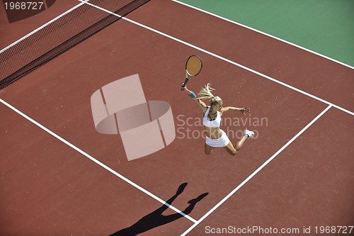 Image of young woman play tennis outdoor