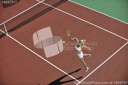 Image of young woman play tennis outdoor
