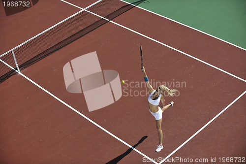 Image of young woman play tennis outdoor
