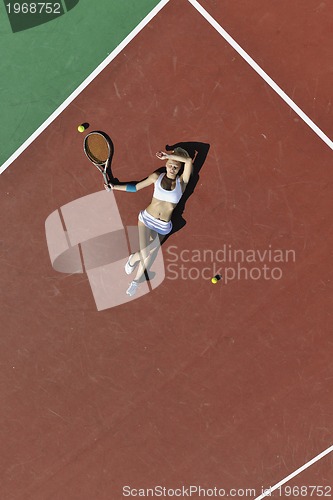 Image of young woman play tennis outdoor