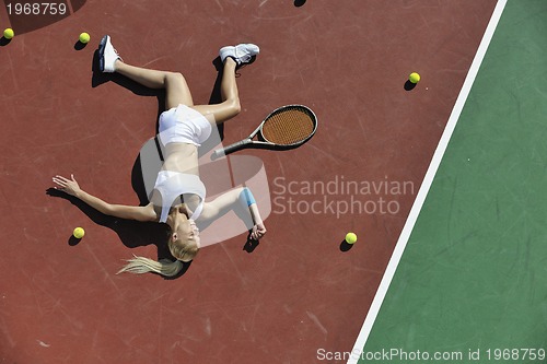 Image of young woman play tennis outdoor