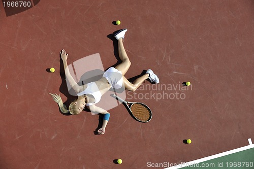 Image of young woman play tennis outdoor