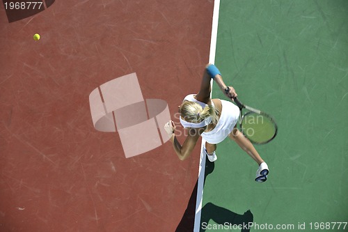 Image of young woman play tennis outdoor