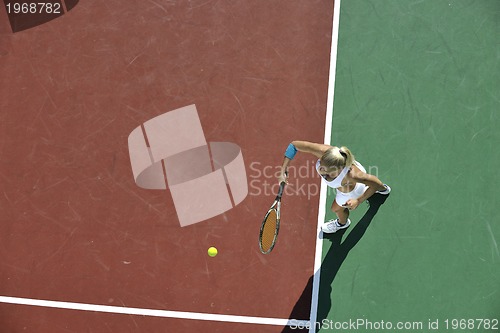 Image of young woman play tennis outdoor