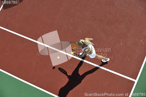 Image of young woman play tennis outdoor
