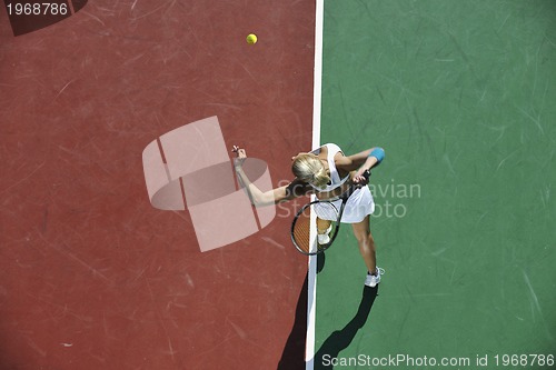 Image of young woman play tennis outdoor