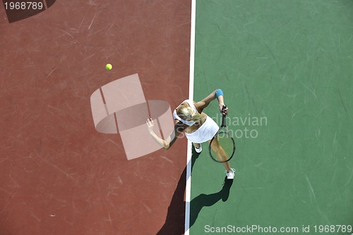 Image of young woman play tennis outdoor