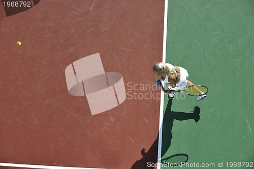 Image of young woman play tennis outdoor