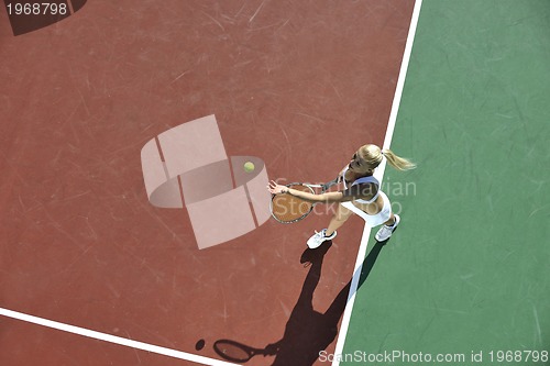 Image of young woman play tennis outdoor