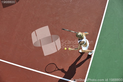 Image of young woman play tennis outdoor