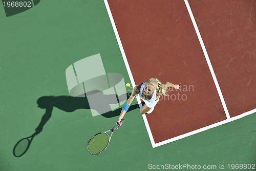 Image of young woman play tennis outdoor
