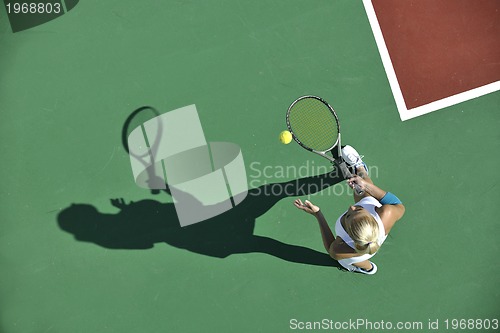 Image of young woman play tennis outdoor