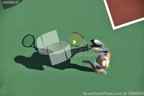 Image of young woman play tennis outdoor