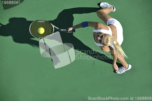 Image of young woman play tennis outdoor