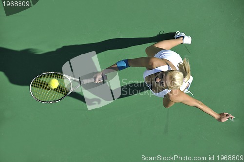Image of young woman play tennis outdoor