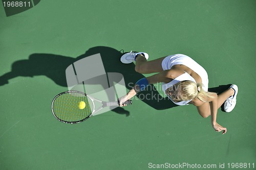 Image of young woman play tennis outdoor