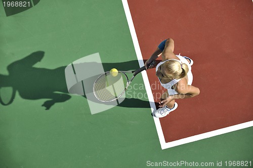 Image of young woman play tennis outdoor