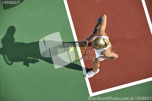 Image of young woman play tennis outdoor