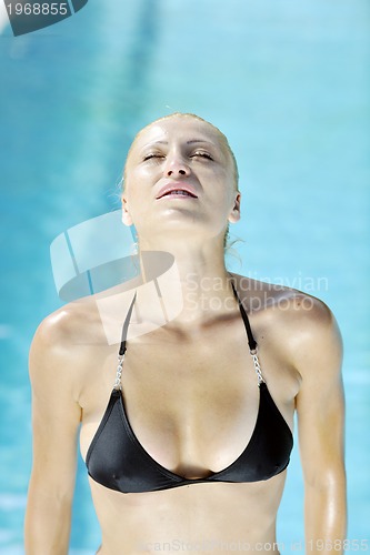 Image of beautiful woman relax on swimming pool