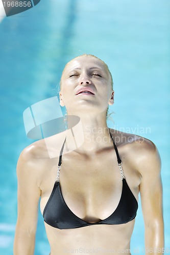 Image of beautiful woman relax on swimming pool