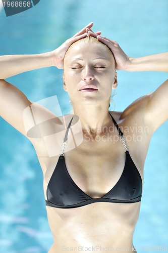 Image of beautiful woman relax on swimming pool