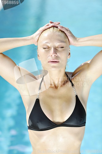 Image of beautiful woman relax on swimming pool