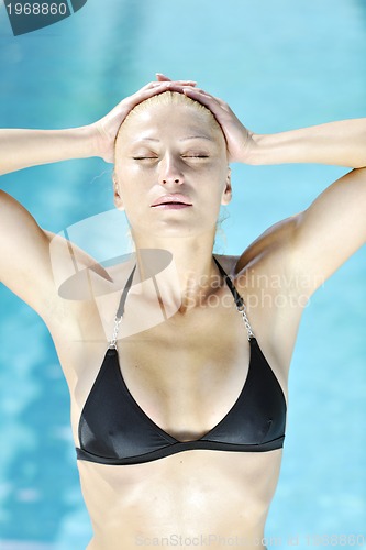 Image of beautiful woman relax on swimming pool