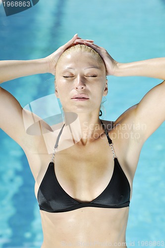 Image of beautiful woman relax on swimming pool
