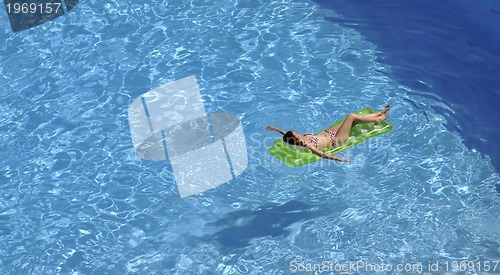 Image of woman relax at swimming pool 