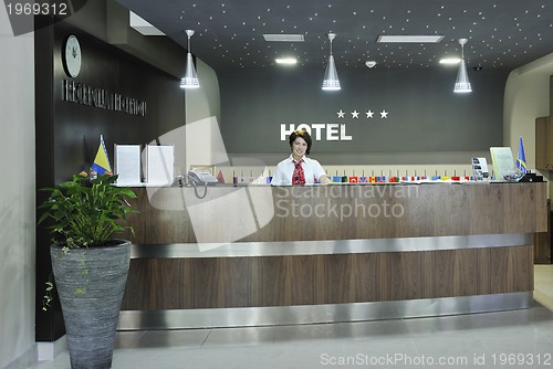 Image of smiling businesswoman at the reception desk