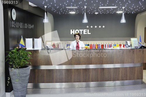 Image of smiling businesswoman at the reception desk