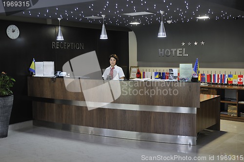 Image of smiling businesswoman at the reception desk