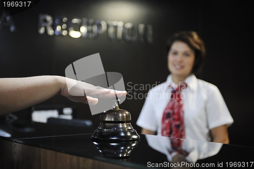 Image of smiling businesswoman at the reception desk