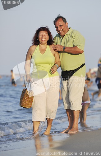 Image of happy seniors couple  on beach