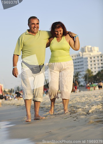 Image of happy seniors couple  on beach