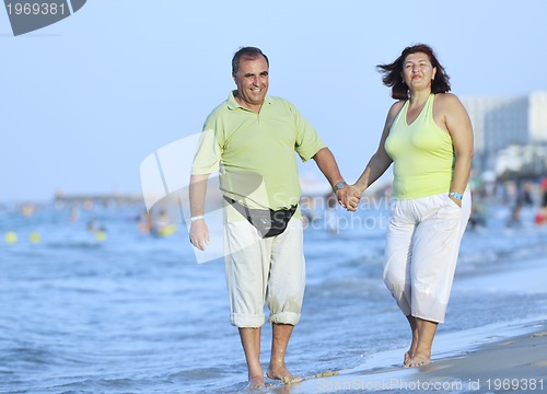 Image of happy seniors couple  on beach