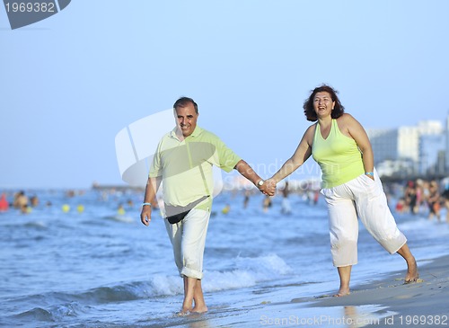 Image of happy seniors couple  on beach