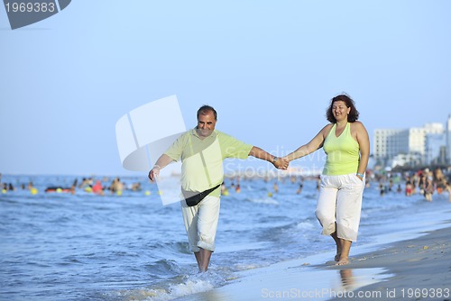 Image of happy seniors couple  on beach