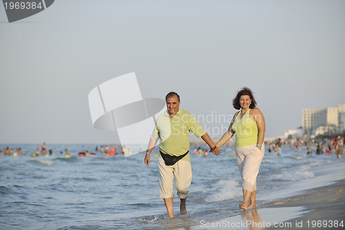 Image of happy seniors couple  on beach